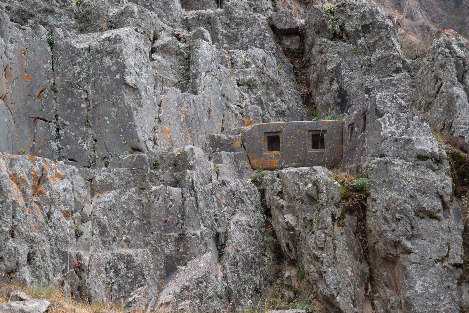 Ollantaytambo in peru Inca ruin in grey stone wall with brown and green moss