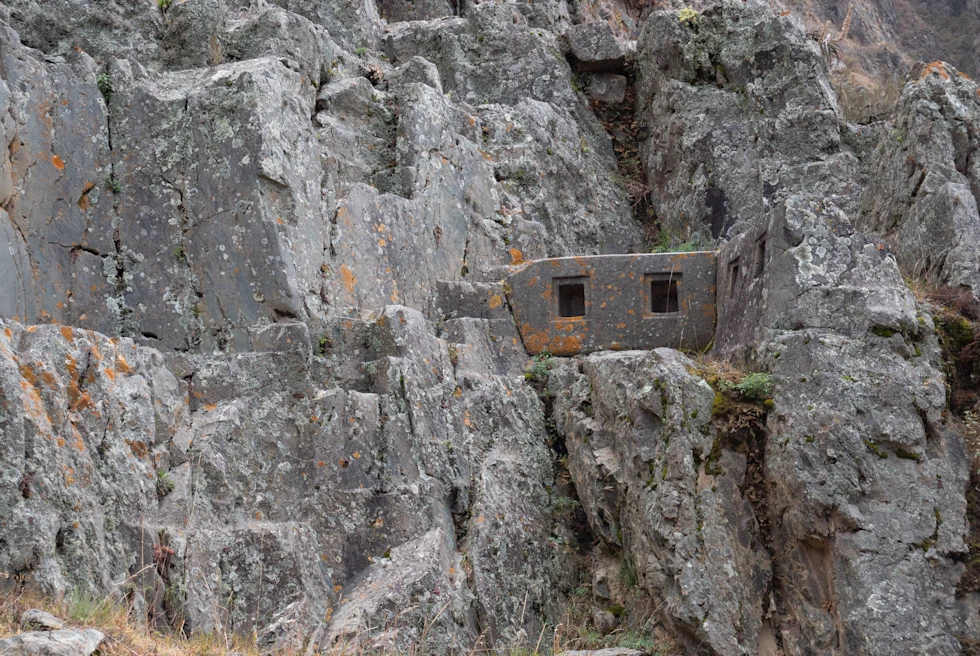 Ollantaytambo in peru Inca ruin in grey stone wall with brown and green moss