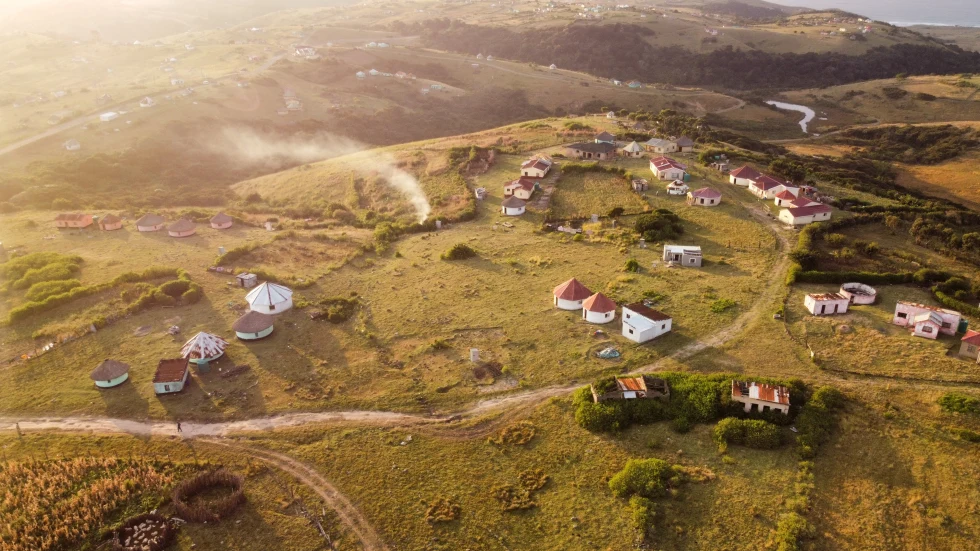aerial view of land with houses during sunset