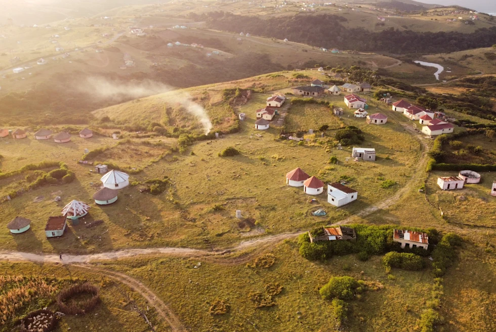 aerial view of land with houses during sunset