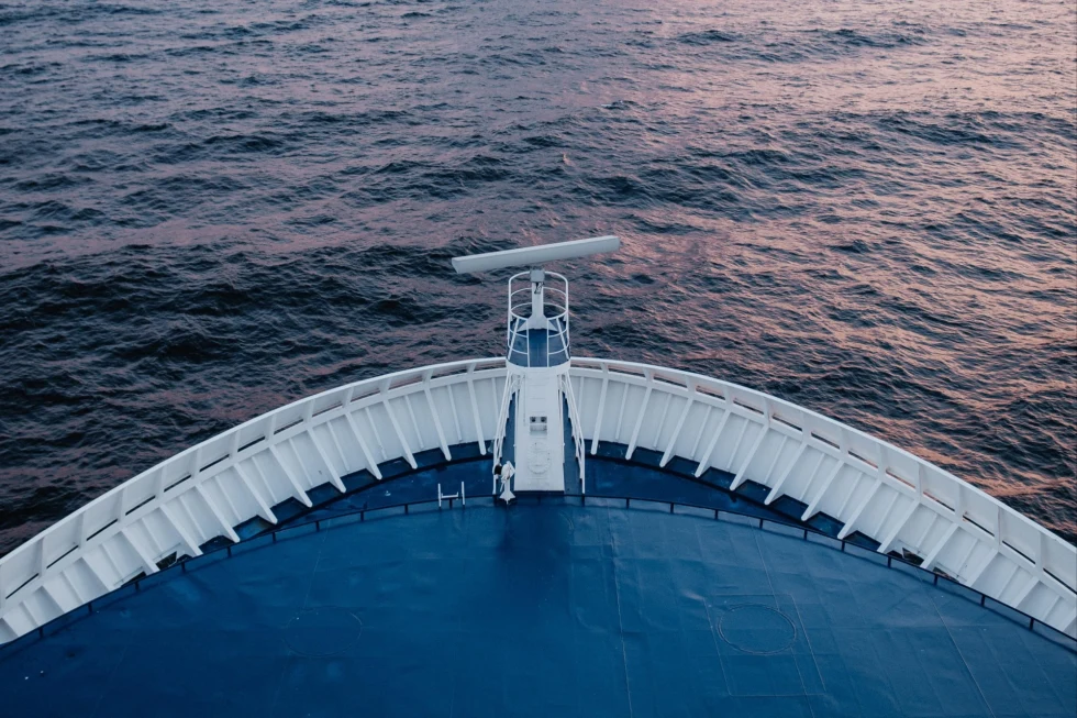 blue cruise ship bow overlooking the sea at dusk