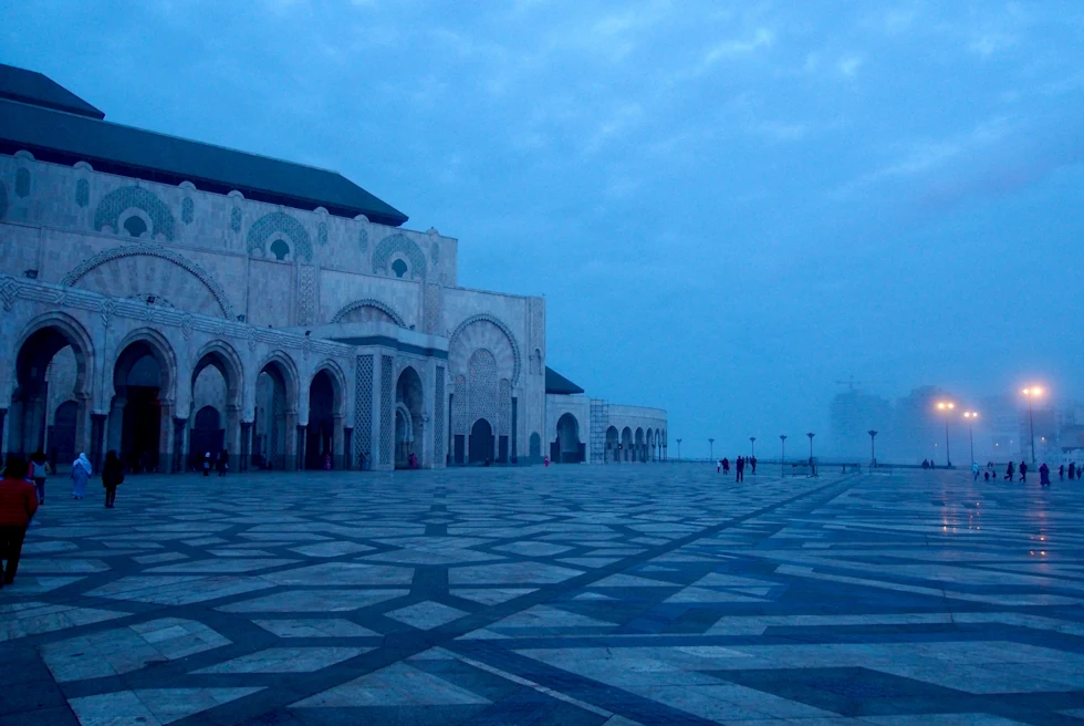 Architectural building with a man walking at night time.