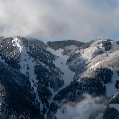 snow-covered mountain with ski trails during daytime