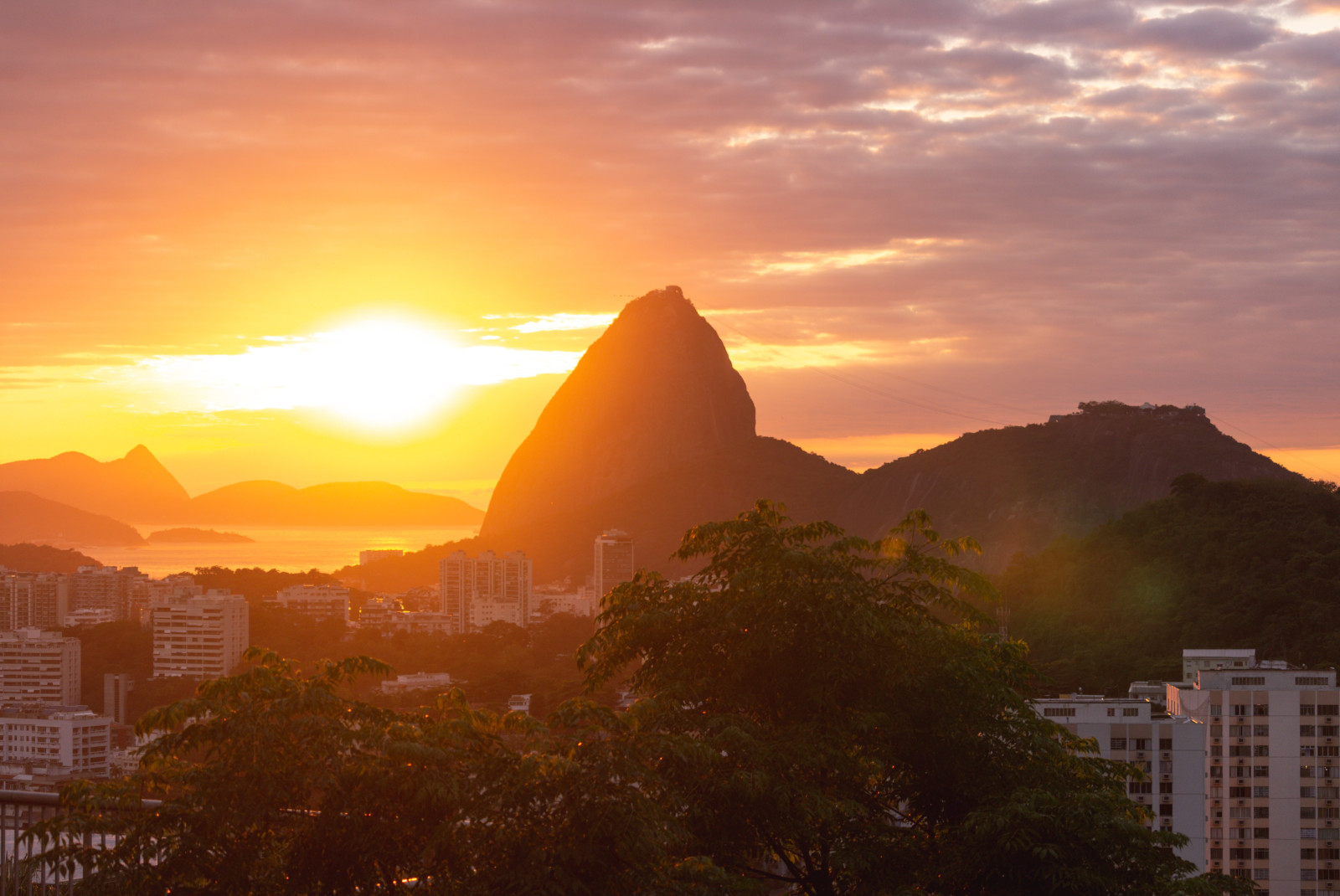 View of the sun rising over Sugarloaf Mountain in Brazil