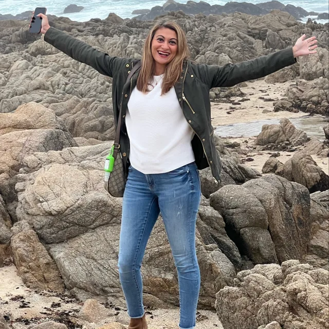Travel advisor posing on a seaside rock