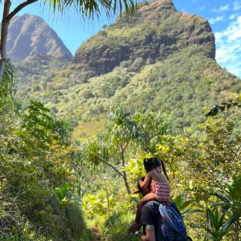 A picture of a man with a kid on his shoulders.