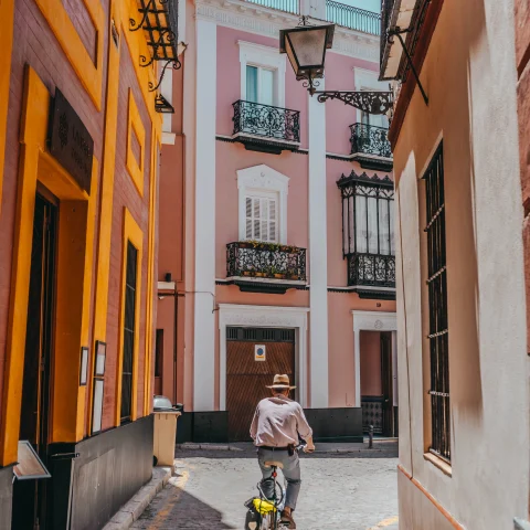 A man riding his bike through Seville, Spain. 
