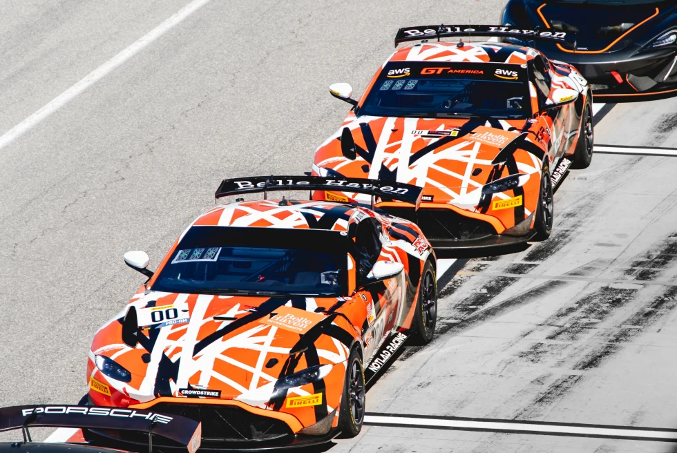 orange cars on a speedway