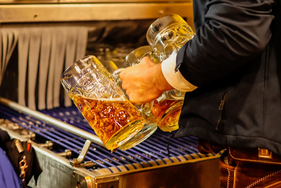 A man with giant pint of beer at Oktoberfest.