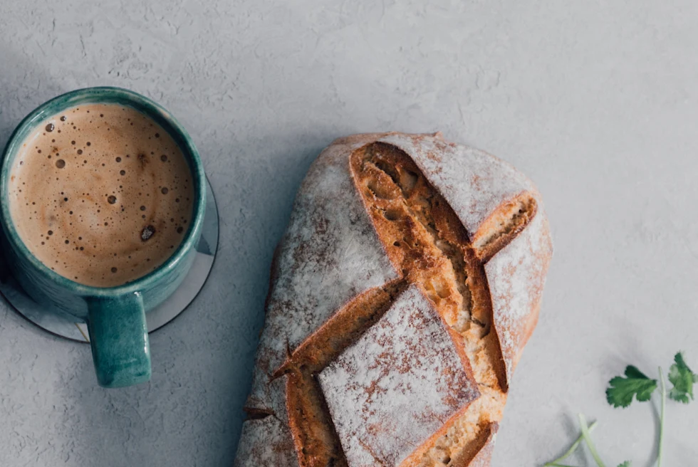 bread and cup of coffee on wood table