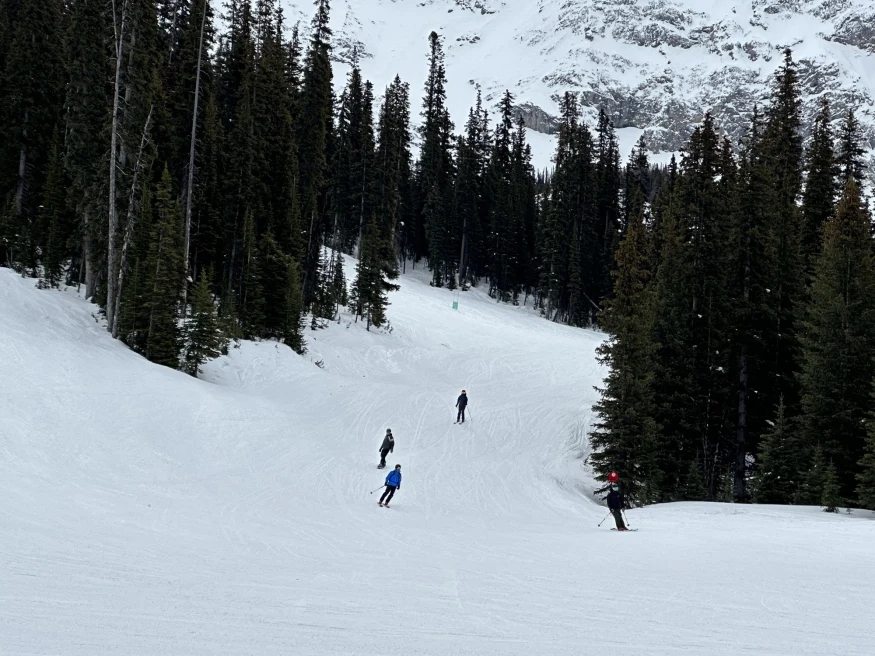ski mountain with 3 skiiers