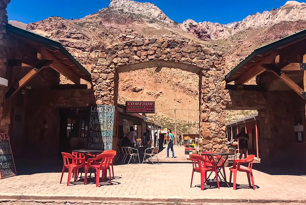 An outdoor restaurant setting near brown mountains.