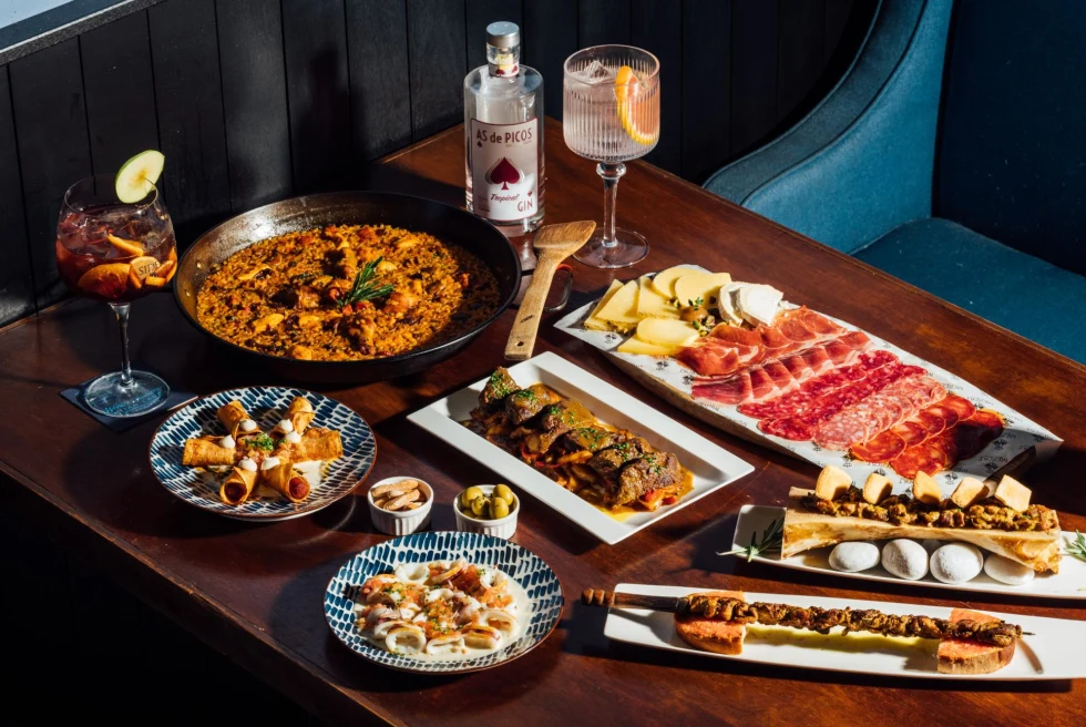 Dining table set up with tapas and drinks. 