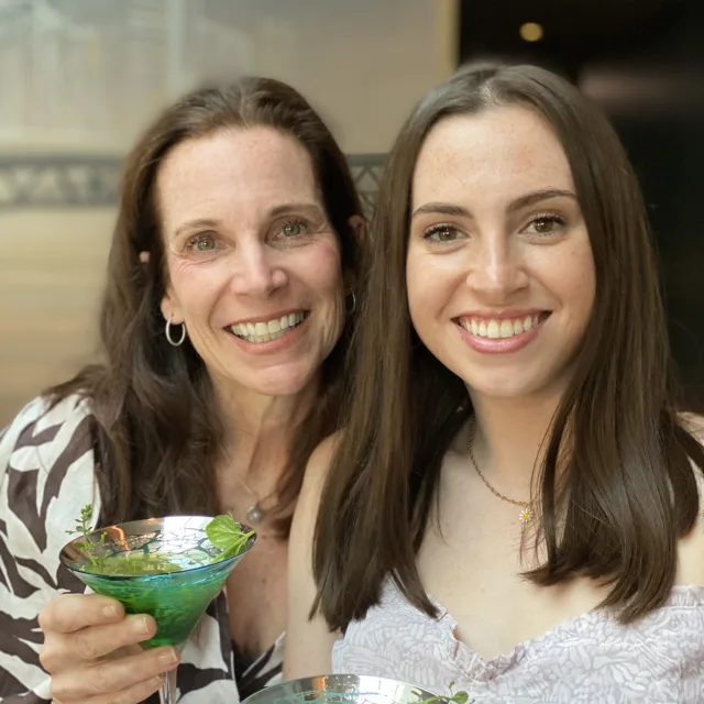 Travel advisor Julie Middlebrook-Levin with her daughter holding green and blue martini glasses
