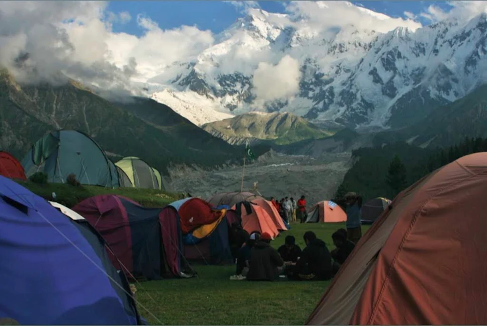 many tents set up at the base of mountain range
