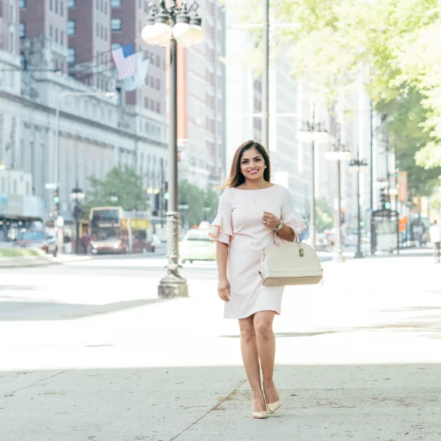 Travel advisor posing in white dress on the roadside