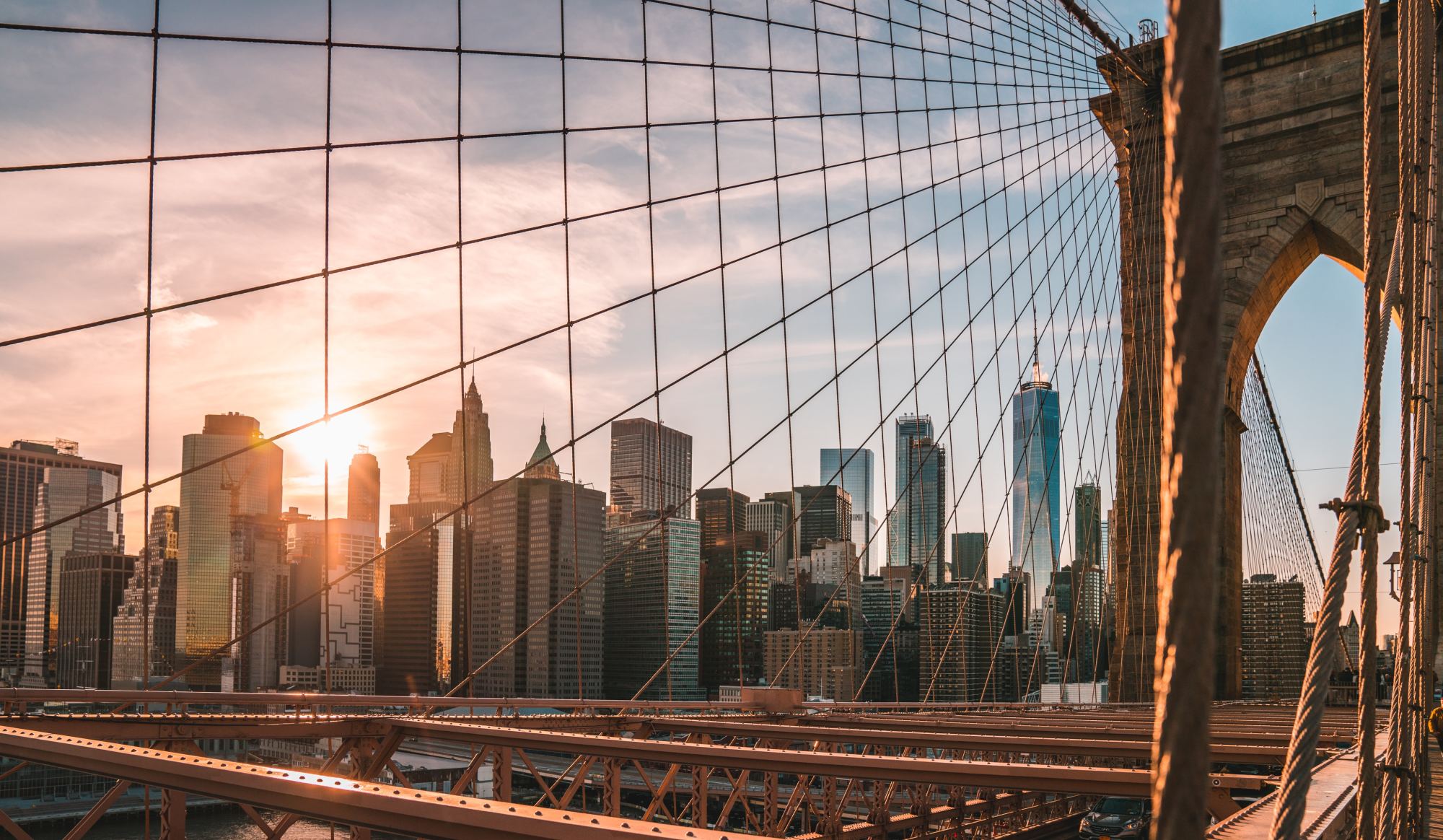 Sunset among the buildings as seen from a the Brooklyn Bridge.