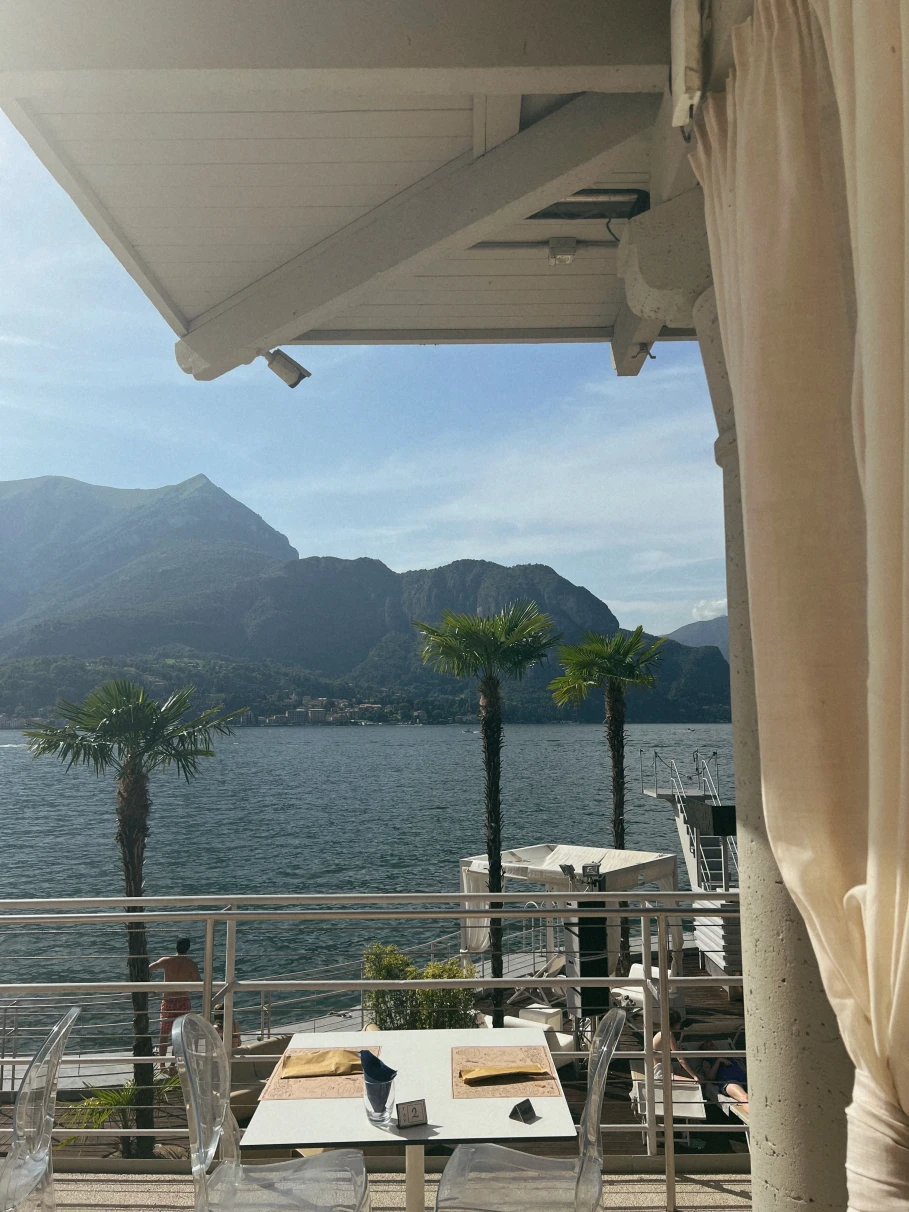 Seaside outdoor patio of Lido restaurant in Lake Como, Italy on a sunny day.