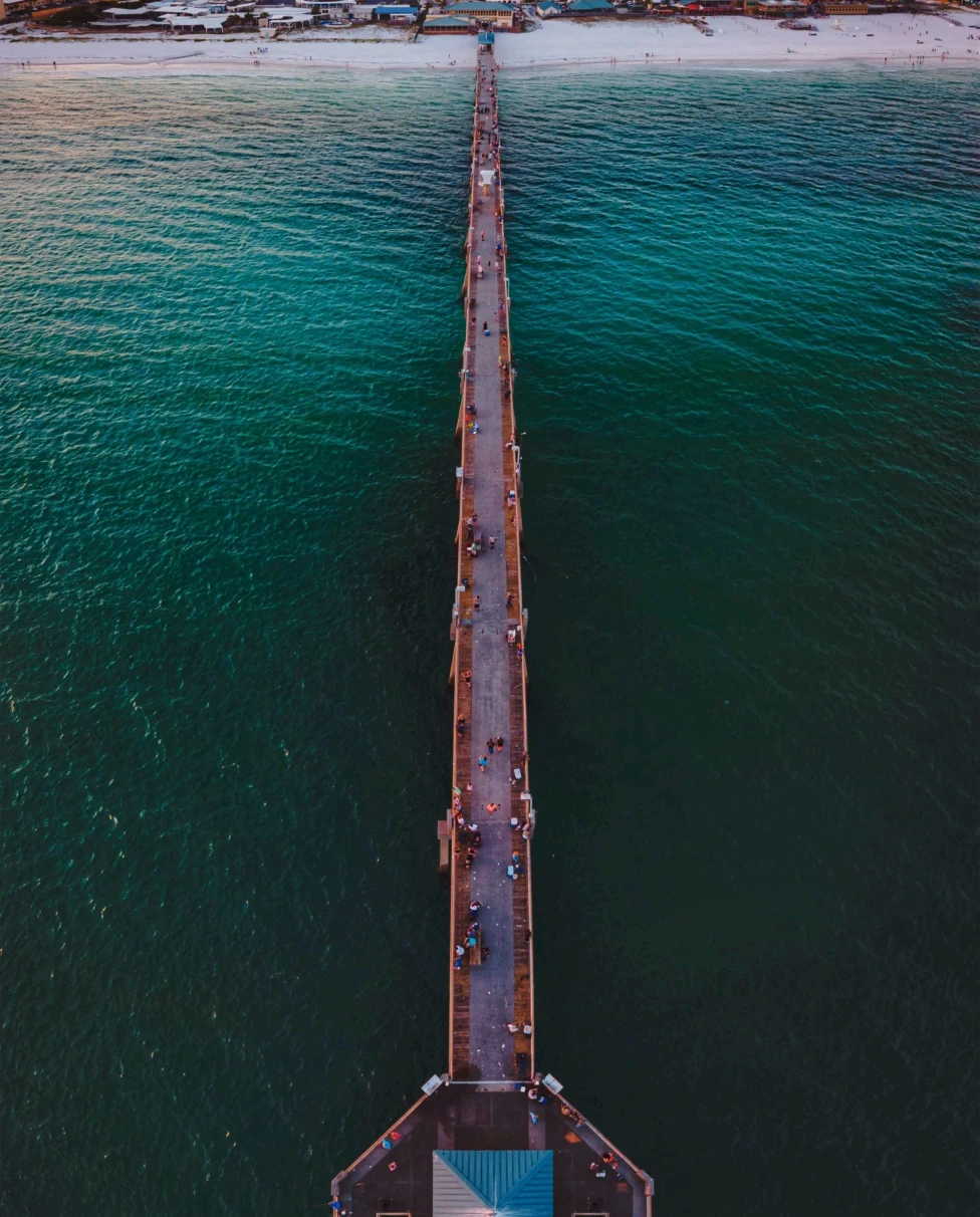 long jetty in the ocean leading to an island
