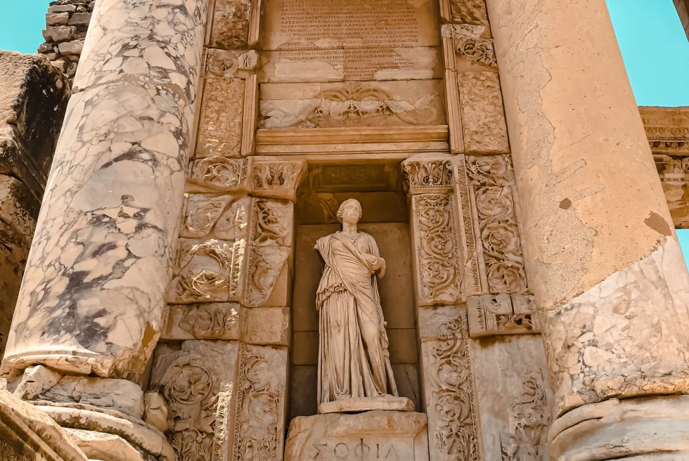statue of a woman between two stone pillars