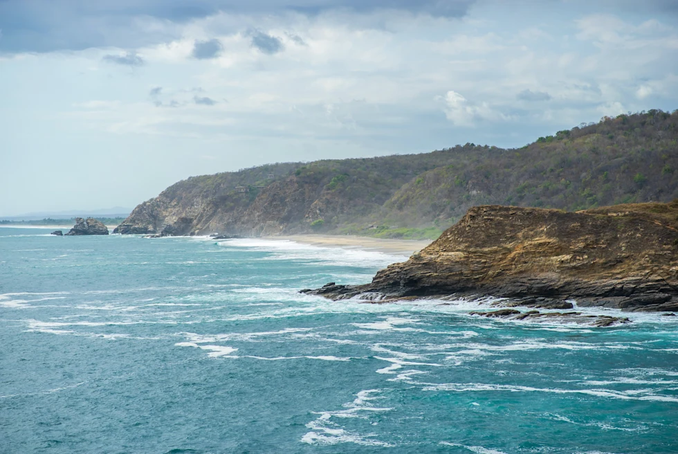ocean next to cliffs during daytime