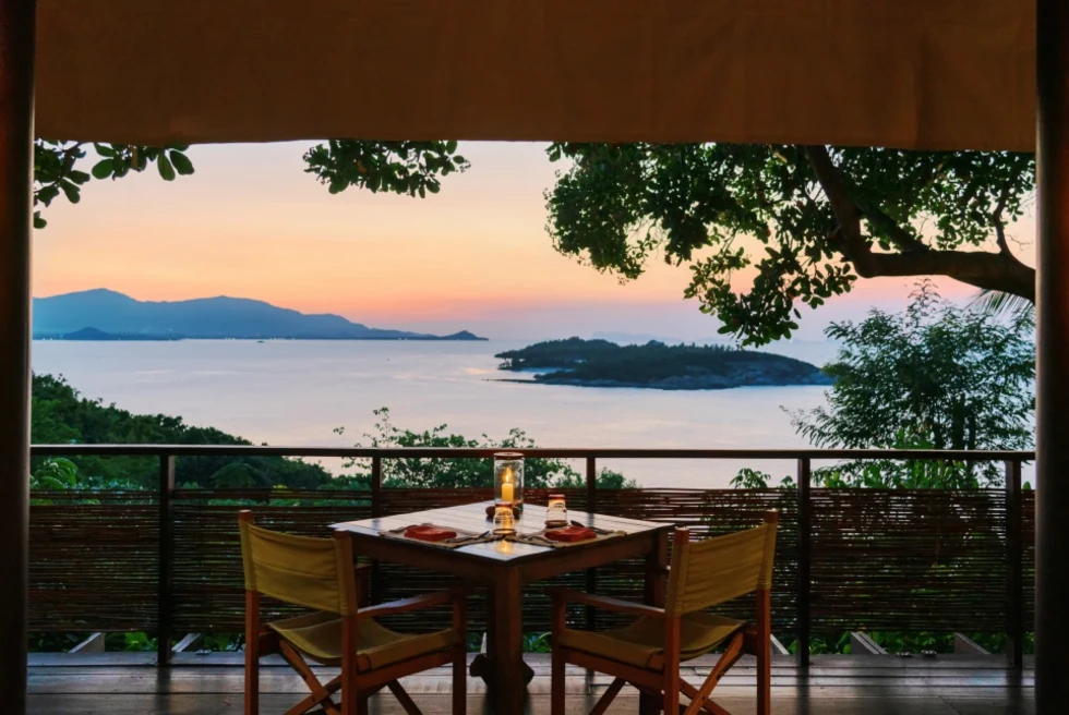 table in a room overlooking body of water