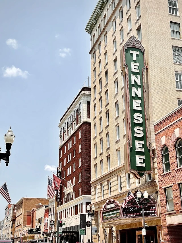 brown concrete building with green and white signage reading "TENNESSEE"
