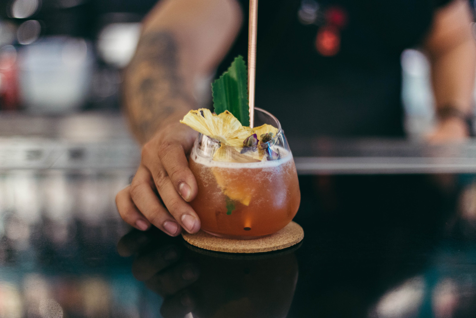 Bartender serves tropical drink