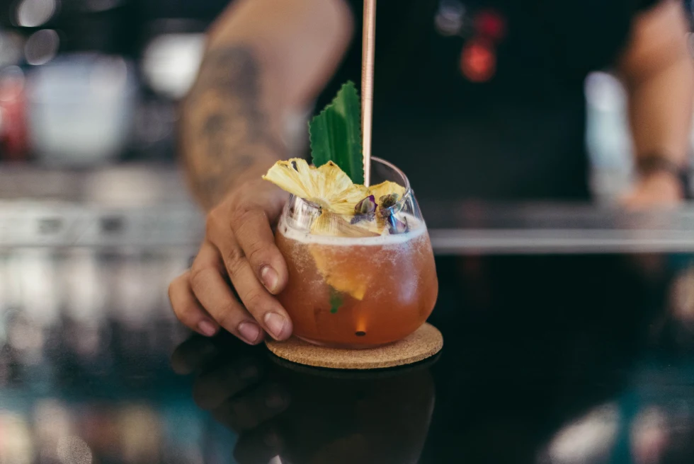Bartender serves tropical drink