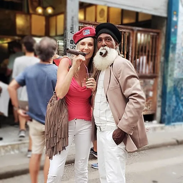 Travel advisor Magdalena Chwalek smoking a cigar with a bearded man