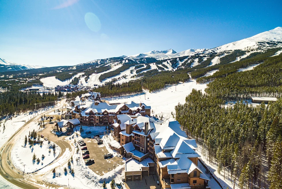 village next to ski mountain during daytime