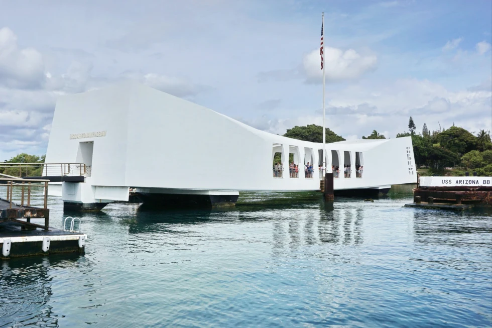 geometric white building over a body of water