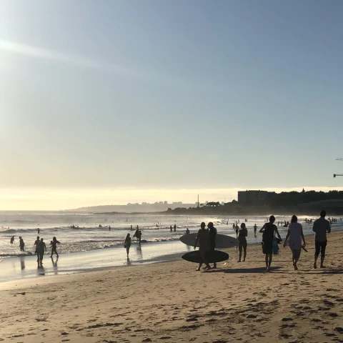 A beach filled with surfers in Lisbon.