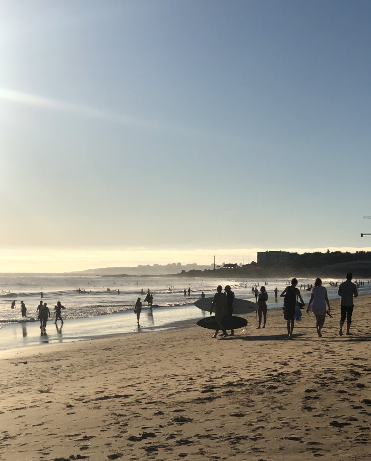 A beach filled with surfers in Lisbon.