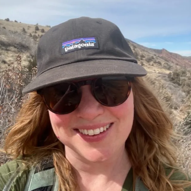 Nicole Bushhouse taking selfie wearing cap and glasses