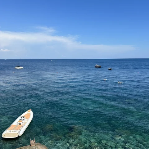 little boat on deep blue waters 