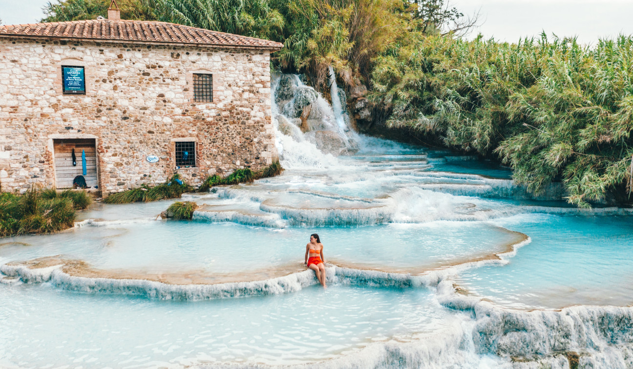 Woman sitting in hot springs in Italy