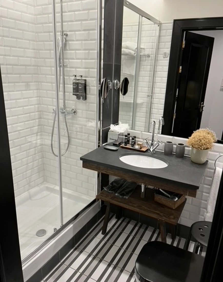 a white-tiled bathroom shower