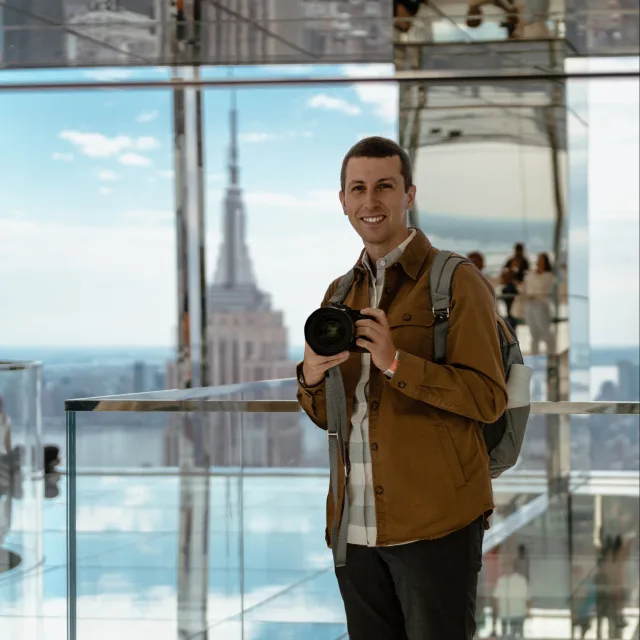 Travel advisor posing in a glass building