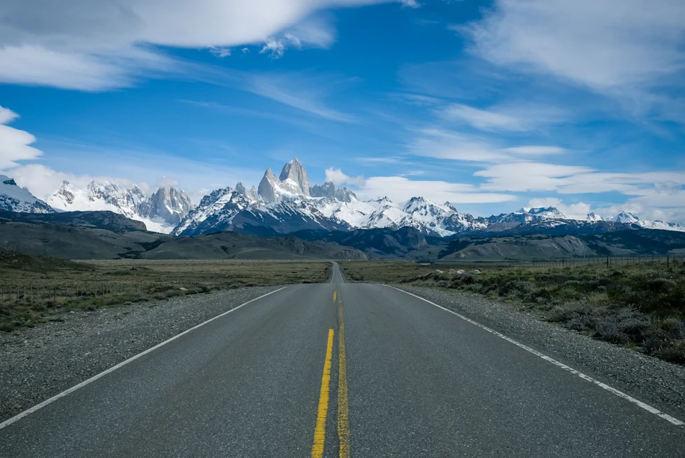 road leading to snow-capped mountains