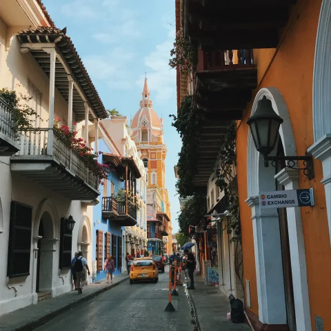 colorful historic narrow street with cars at daytime