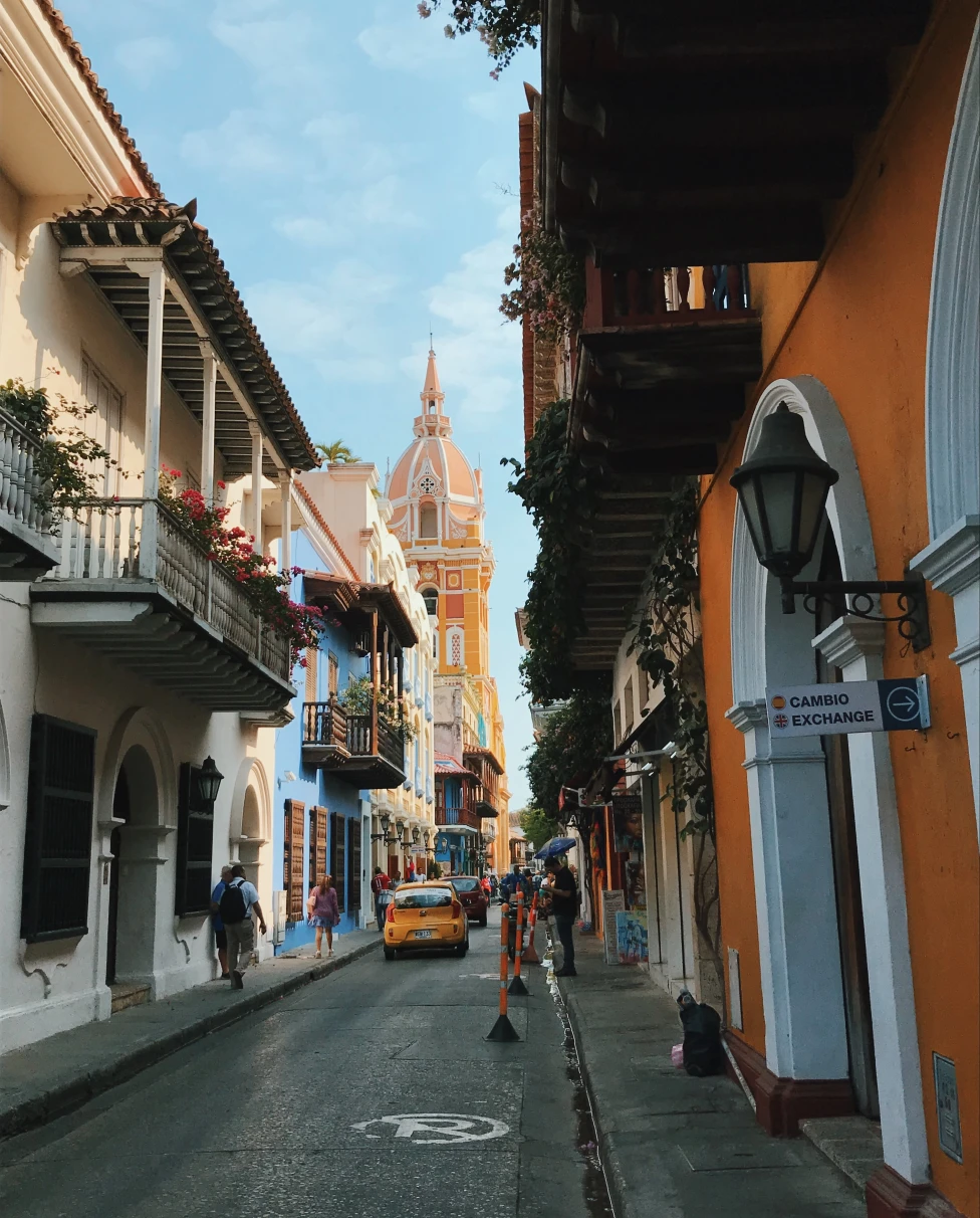 colorful historic narrow street with cars at daytime