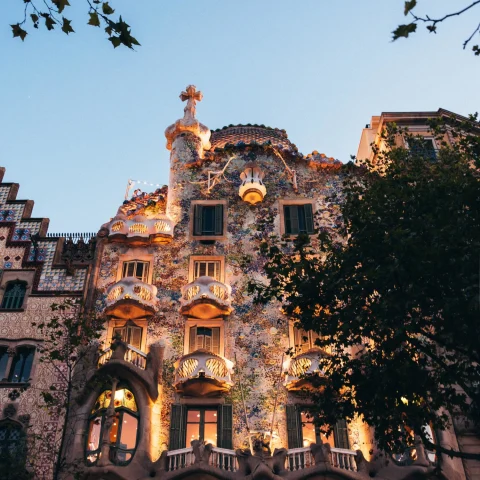 Antoni Gaudi's building in Barcelona at lit up at night.