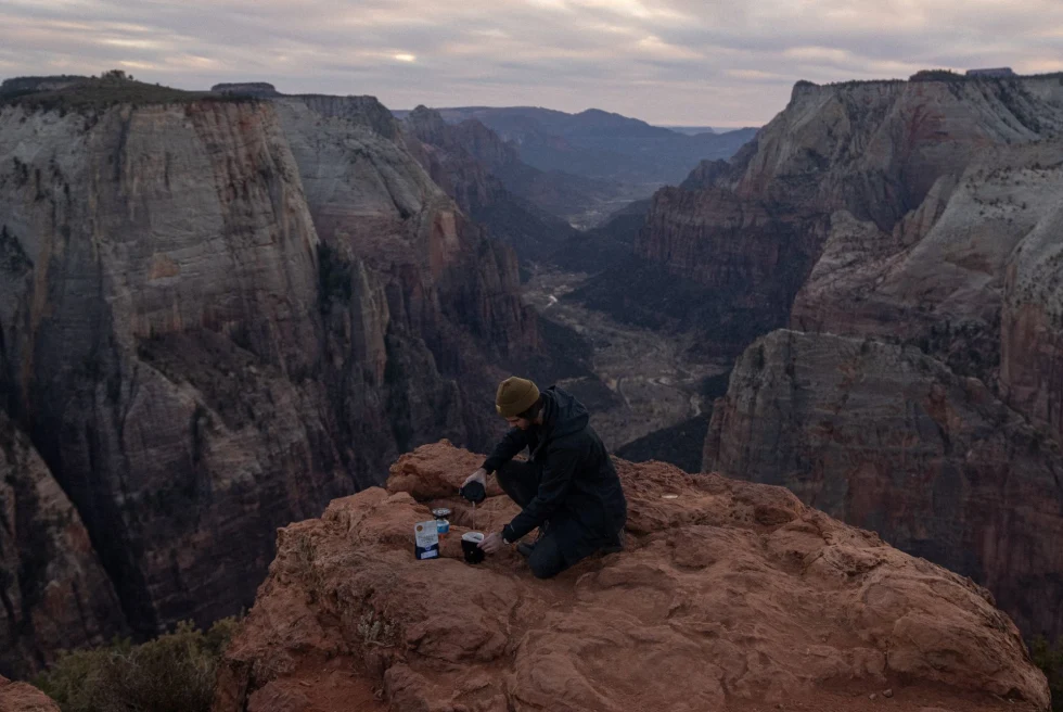 man pours drinks into cups on top of Zion National Park