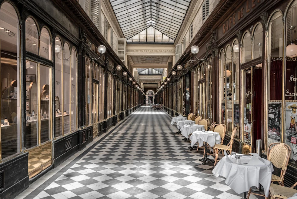 Hallway with checkered floor with patio seating in Paris.