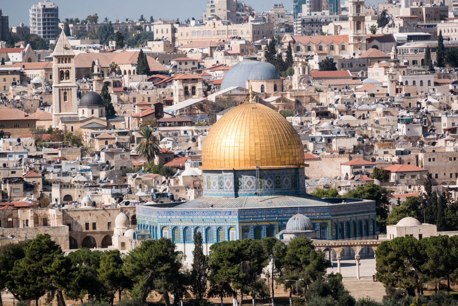 large blue building with gold dome surrounded by buildings