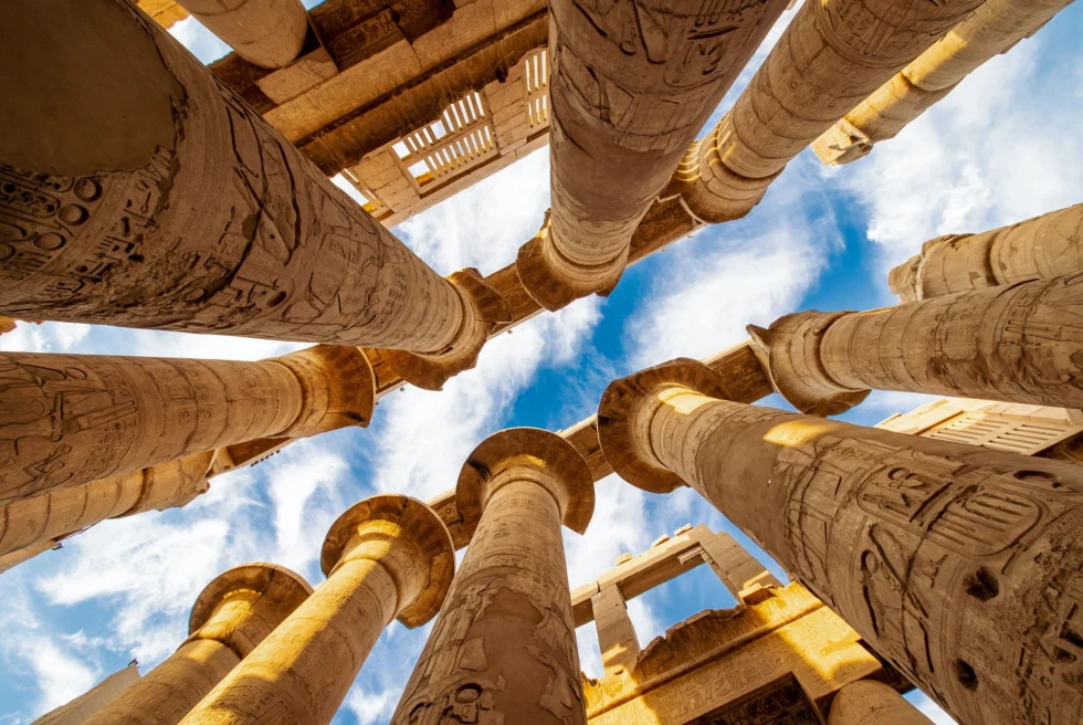 low-angle view of stone pillars against a blue sky
