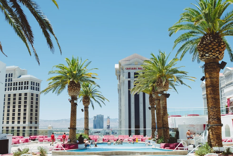 a hotel pool with buildings in the background