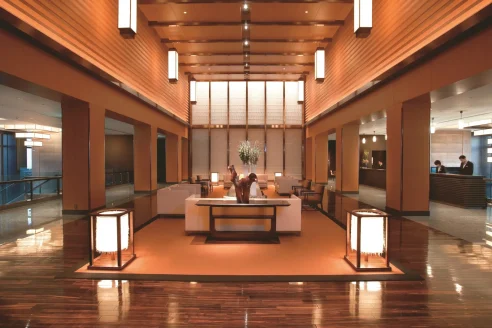 a modern lobby with rectangular lanterns and wooden accents