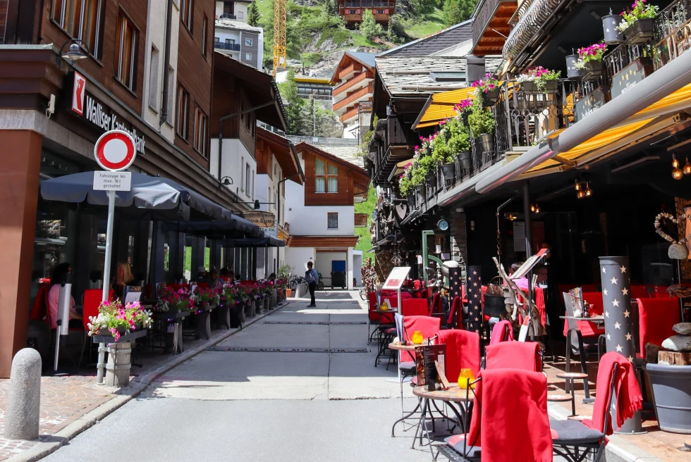 tables outside on the sidewalk during daytime